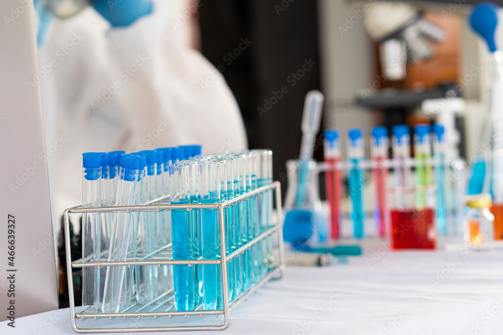 Doctors or scientists who analyze health research studies are conducting research by testing chemical droplets in test tubes of various colors and working in life science laboratories. Doctors or scientists who analyze health research studies are conducting research by testing chemical droplets in test tubes of various colors and working in life science laboratories.