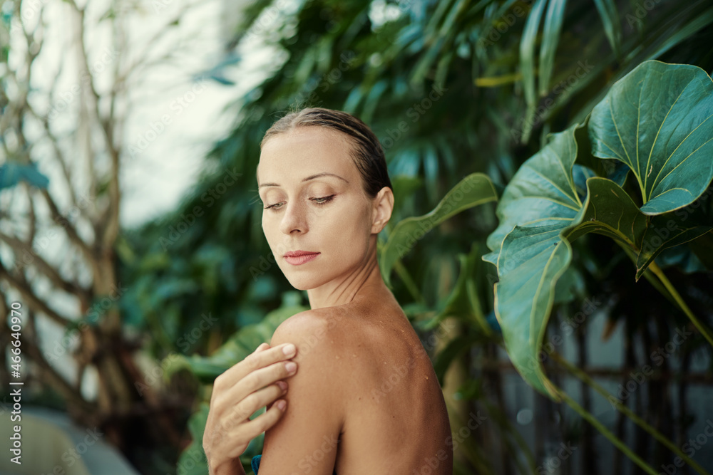 Close up outdoor portrait of young beautiful woman against green tropical leaves. Close up outdoor portrait of young beautiful woman against green tropical leaves.
