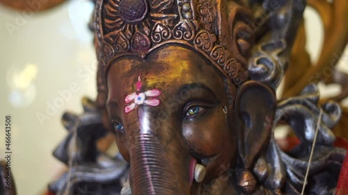 ganpati statue  of Indian god dark stone slow motion  face close up photo