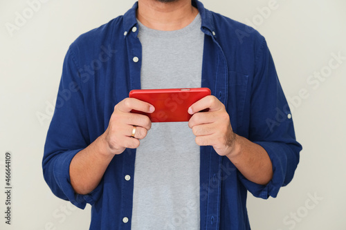 Cropped guy playing mobile game isolated white background