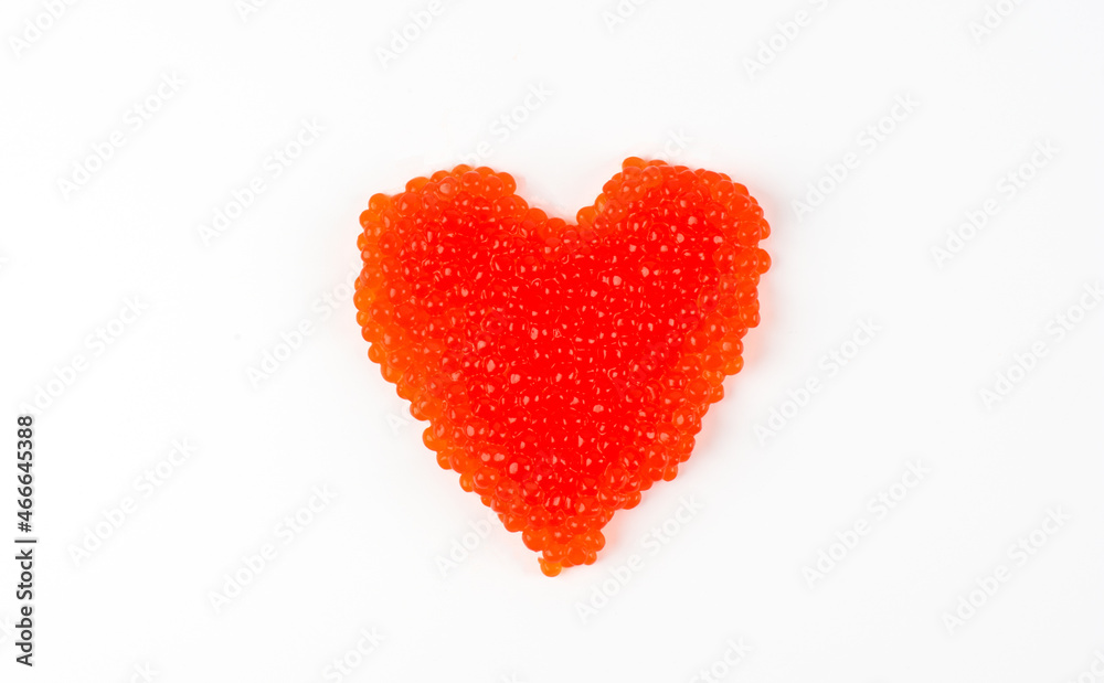 Heart shaped red caviar isolated on white background. Sandwich in the form of a heart on a white background. big heart from the red caviar over white. valentine red caviar heart isolated on white