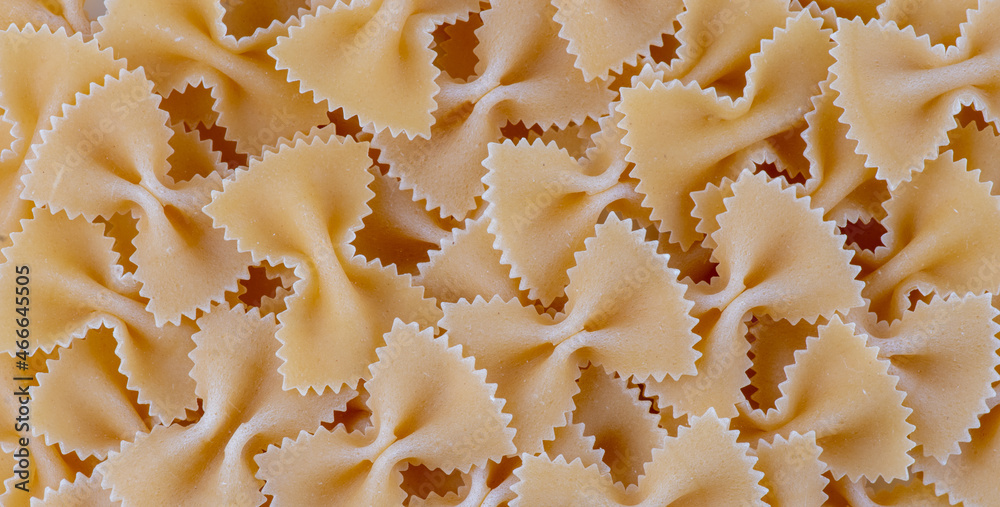 dry raw italy pasta spahgetti. Solid background of raw pasta. Closeup dry macaroni background. Textured kitchen background of food.