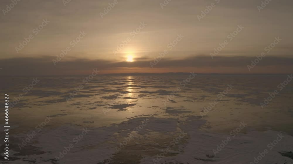 Winter landscape flight over frozen Lake Baikal, video filming at sunset Winter landscape flight over frozen Lake Baikal, video filming at sunset