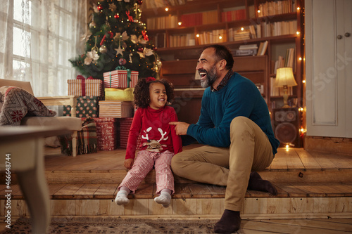 Father and daughter while celebrating Christmas at home