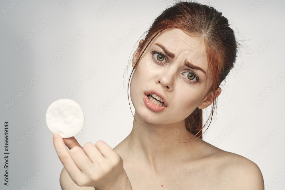 woman with bare shoulders cotton pad clean skin light background woman with bare shoulders cotton pad clean skin light background