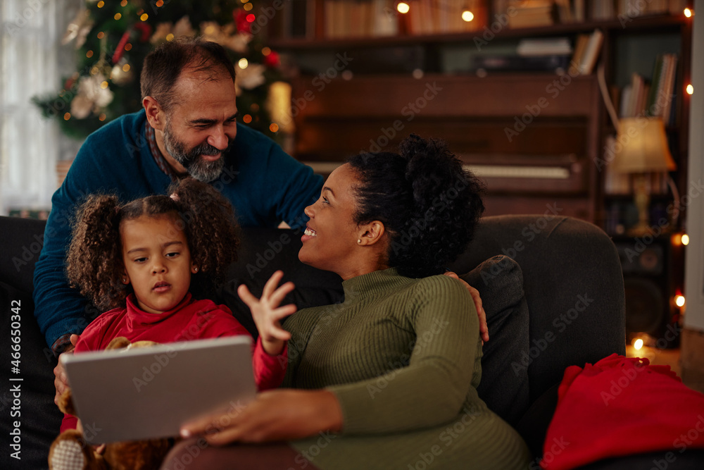 Mixed race family using digital tablet Mixed race family using digital tablet