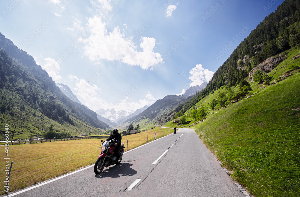 Moto trip. Lifestyle and travel. Beautiful landscape. A road through the Swiss Alps, Switzerland. Moto trip. Lifestyle and travel. Beautiful landscape. A road through the Swiss Alps, Switzerland.
