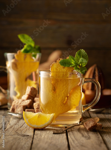 Ginger tea with ingredients on an old wooden table.