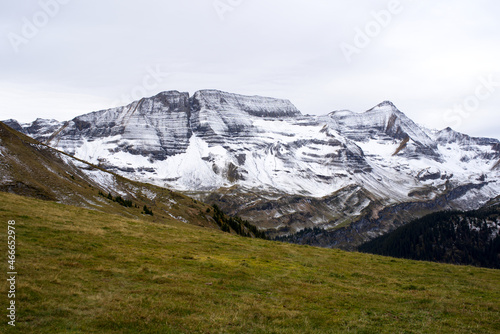 Mountain panorama with fresh snow seen from Axalp at Bernese Highlands on a grey cloudy autumn day. Photo taken October 19th, 2021, Brienz, Switzerland.