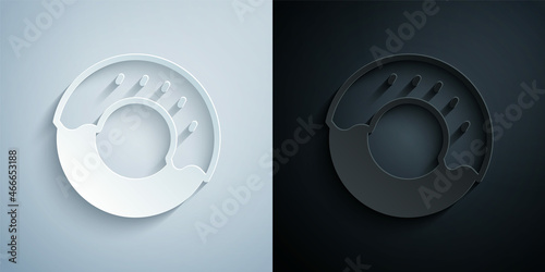 Paper cut Donut with sweet glaze icon isolated on grey and black background. Paper art style. Vector