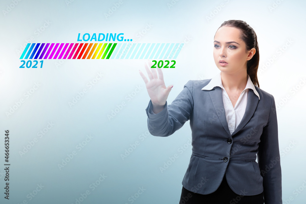 Businesswoman pressing virtual button with year 2022 Businesswoman pressing virtual button with year 2022