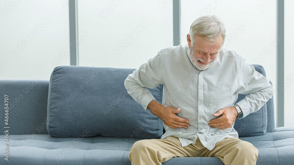 Caucasian old senior elderly unhealthy sick ill male husband grandpa holding hands on stomach