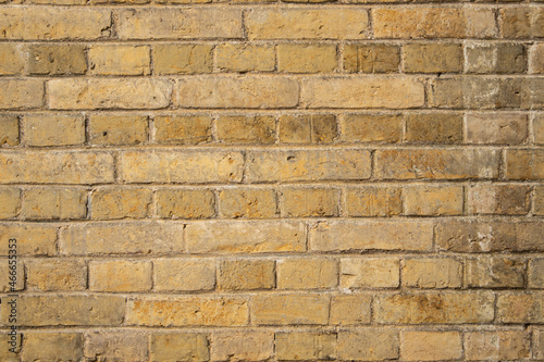 High resolution texture of a yellow brick wall background in the countryside