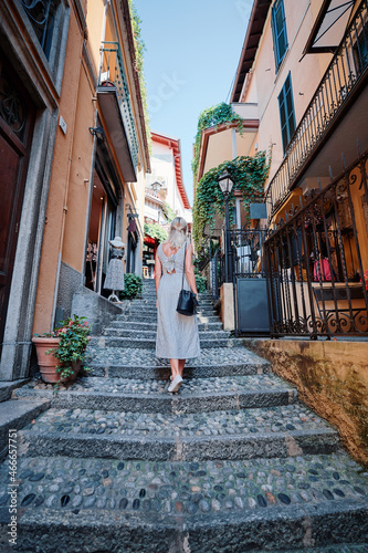 Travel and active lifestyle concept. Young traveller woman walking in old italian town. © luengo_ua