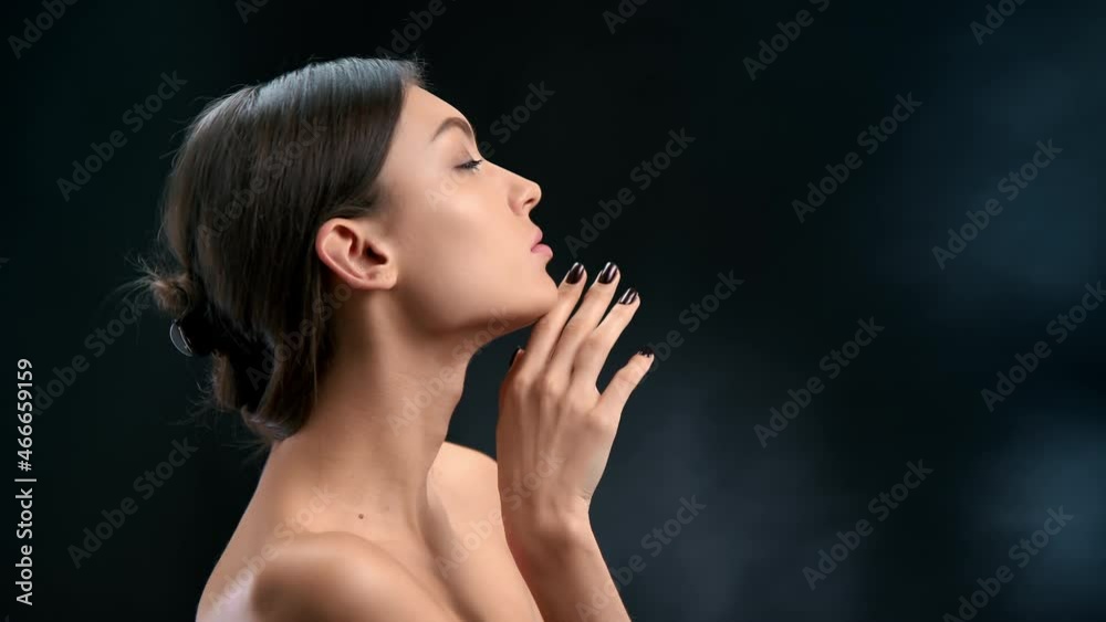 Luxury brunette woman with perfect skin stroking chin enjoying rejuvenation care plastic surgery