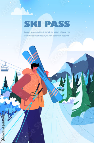 skier man holding skis sportsman skiing doing activities christmas new year holidays celebration winter vacation ski resort