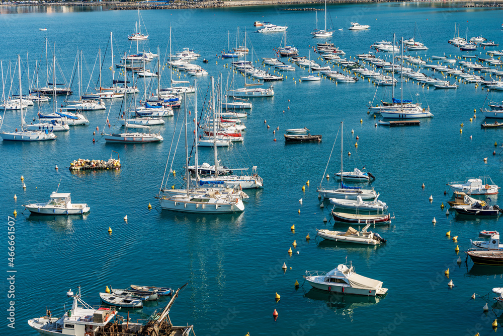 Large group of recreational boats moored in the port of the small village of Lerici, tourist resort on the coast of Gulf of La Spezia, Mediterranean sea, Liguria, Italy, Southern Europe.