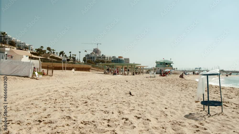 wide view of a modern beach in Israel. People hanging out. wide view of a modern beach in Israel. People hanging out.