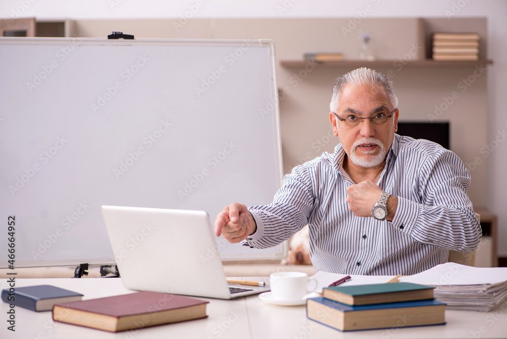 Old male employee working from home during pandemic Old male employee working from home during pandemic
