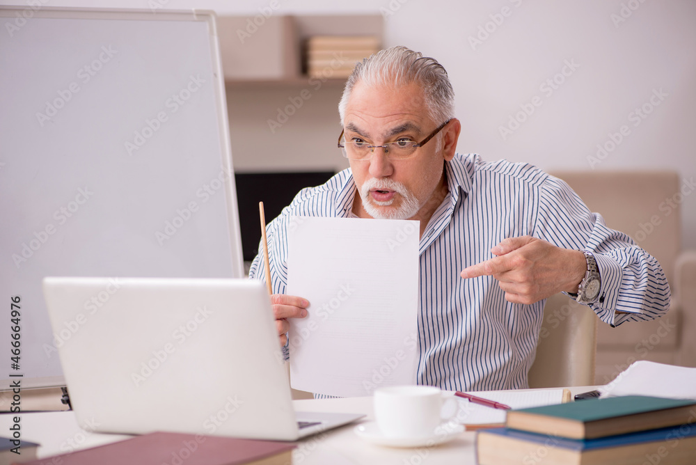 Old male employee working from home during pandemic Old male employee working from home during pandemic