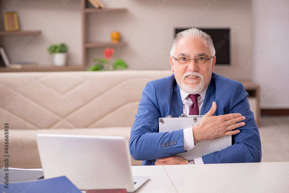 Old male employee in remuneration concept at home Old male employee in remuneration concept at home