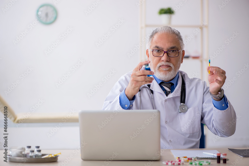 Old male doctor pharmacist working at the lab