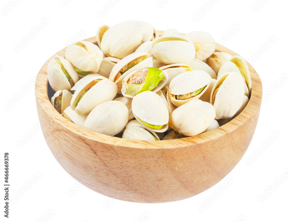 pistachio with shell nuts in wooden bowl isolated on white background. pistachio with shell nuts in wooden bowl isolated on white background.