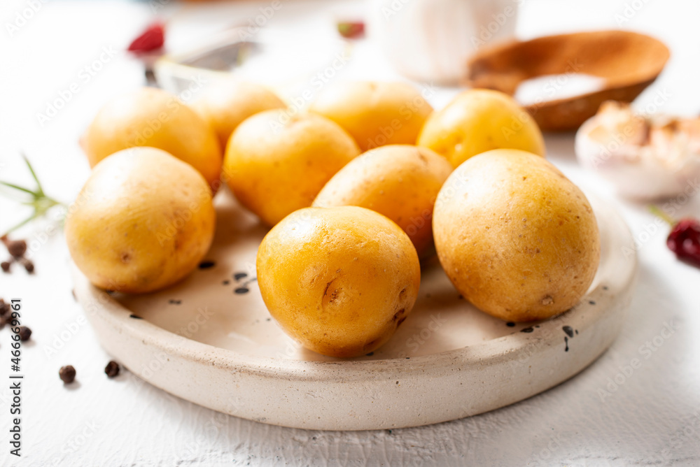 Peeled potatoes for cooking, raw potato on a table Peeled potatoes for cooking, raw potato on a table
