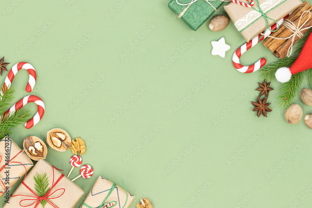 Christmas background with Christmas decoration - gift boxes, candy canes and spices