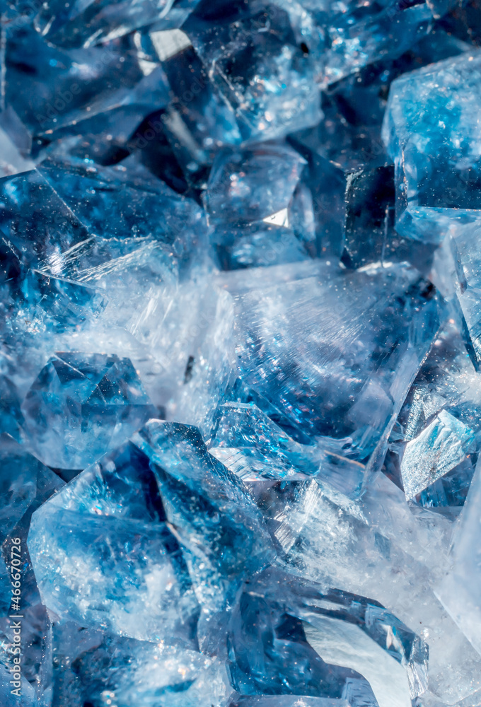 Blue Crystal Mineral Stone. Gems. Mineral crystals in the natural environment. Texture of precious and semiprecious stones. Seamless background with copy space colored shiny surface of precious stones