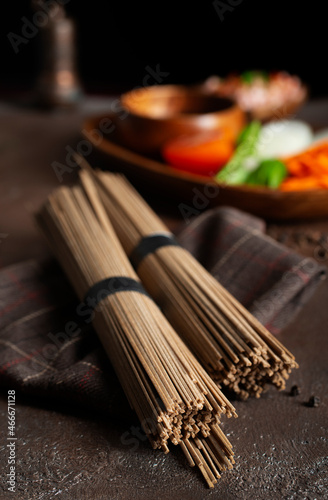 Uncooked soba and udon noodles. Traditional Japanese noodles on wooden table.