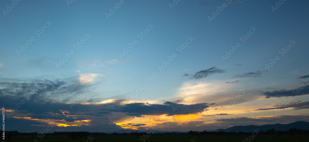 Obraz premium Colorful sunset and sunrise with clouds. Blue and orange color of nature. Many white clouds in the blue sky. The weather is clear today. sunset in the clouds. The sky is twilight.