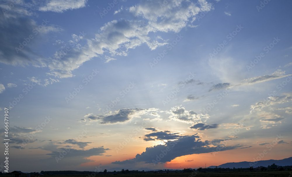 Colorful sunset and sunrise with clouds.Blue and orange color of nature.Many white clouds in the blue sky.The weather is clear today.sunset in the clouds.The sky is twilight.