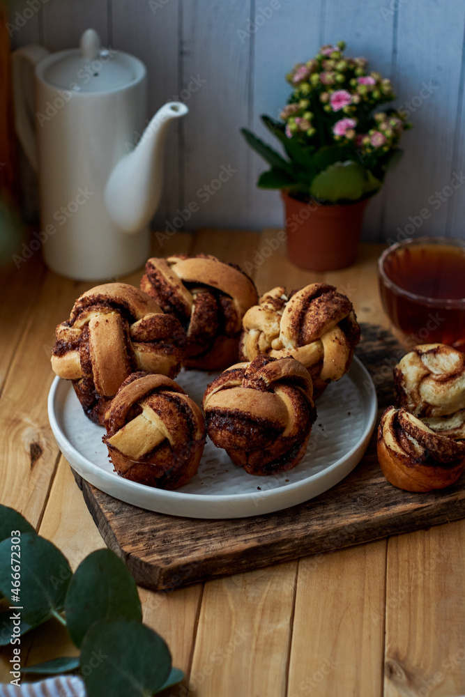 Cinnamon rolls, round yeast buns. Side view, wooden background. Cinnamon rolls, round yeast buns. Side view, wooden background.