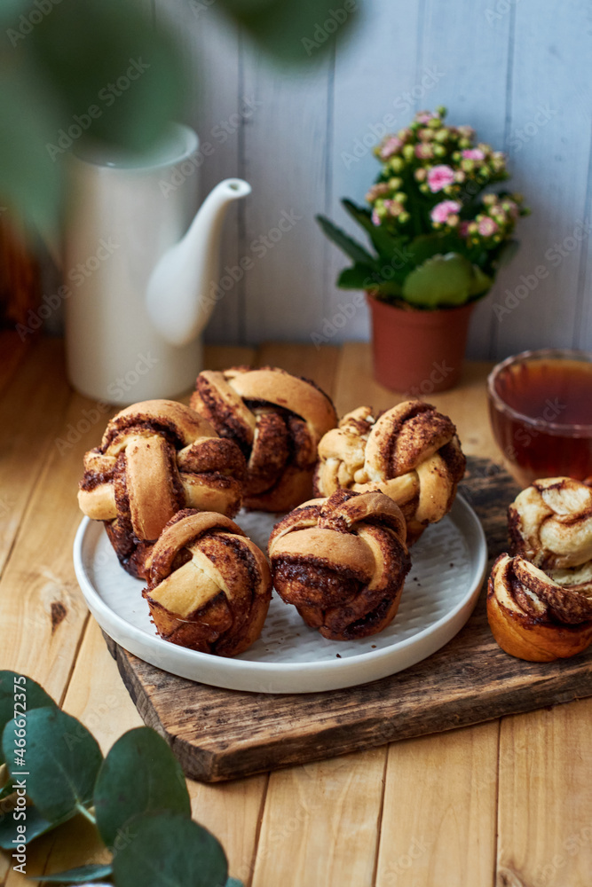 Cinnamon rolls, round yeast buns. Side view, wooden background. Cinnamon rolls, round yeast buns. Side view, wooden background.