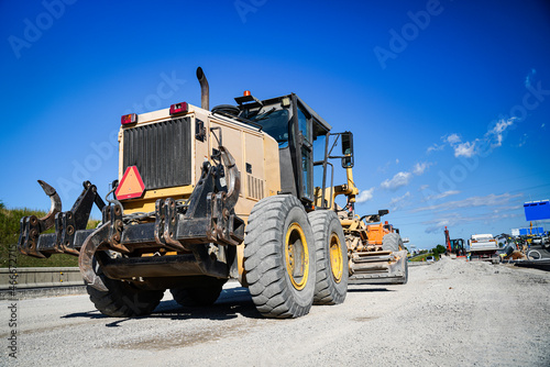 Road grader on the construction site repairing highway.