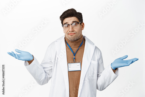 I dont know. Clueless male doctor shrugging shoulders, looking puzzled, have no idea, standing confused against white background