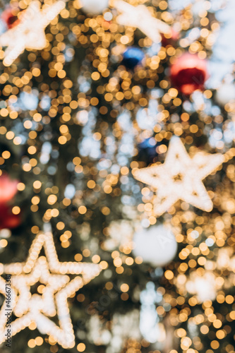 Vertical blurred Christmas background. Christmas decorated Christmas tree with lights, bokeh