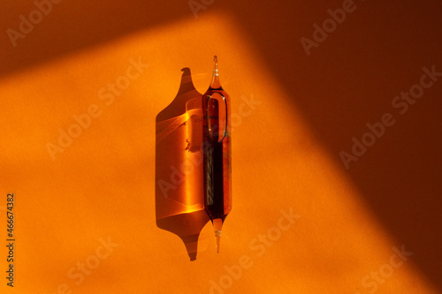 Magnesium capsules on an orange background. Drinking magnesium capsules. Solid background and capsules. 