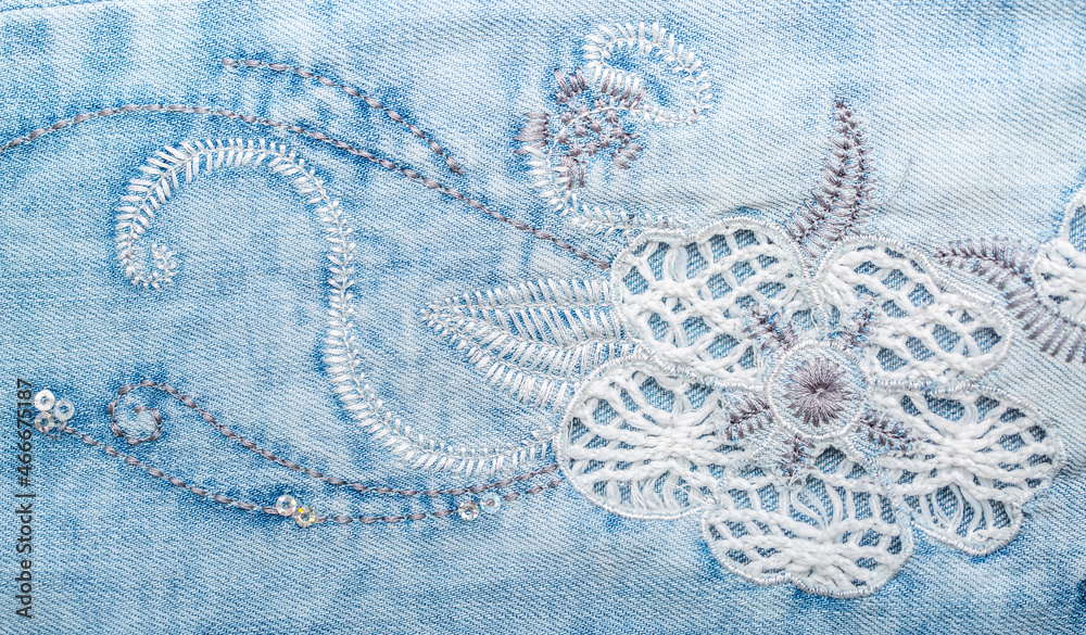 Obraz premium Jeans background. Denim fabric closeup. Textures of clothing fabric with fashion embroidery blue colors. Copy space for text. Fashion and Style.