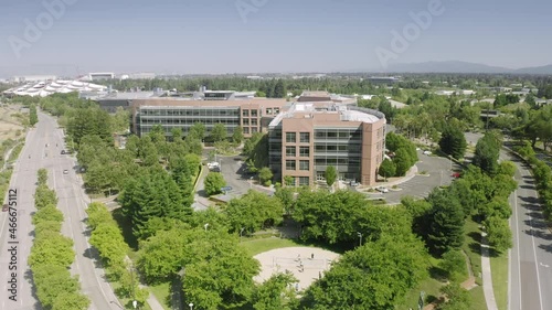 Aerial view of spectacular work environment in Mountain View, California. Google Headquarters complex, surrounded by lush green vegetation, as seen from above. High quality 4k footage