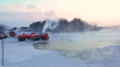 Working special equipment is parked in a severe frost in Chukotka in the sunset light, the footages are removed from the quadcopter