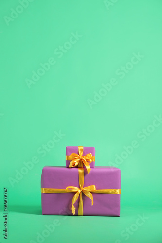 Beautifully wrapped gift boxes on green background. Space for text