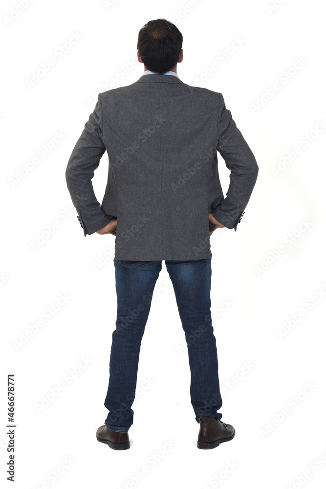 rear view of a man with blazer, jeans and shoes hands on hip on white background rear view of a man with blazer, jeans and shoes hands on hip on white background