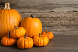 Fresh ripe pumpkins on wooden table, space for text