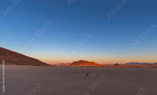 Full moon at sunset in Namib Desert