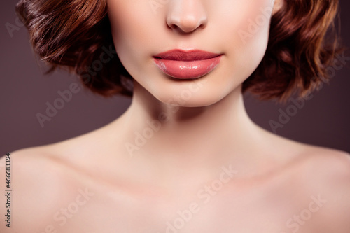 Cropped photo of beautiful stunning female naked shoulders wear glossy nude lipstick isolated on dark color background
