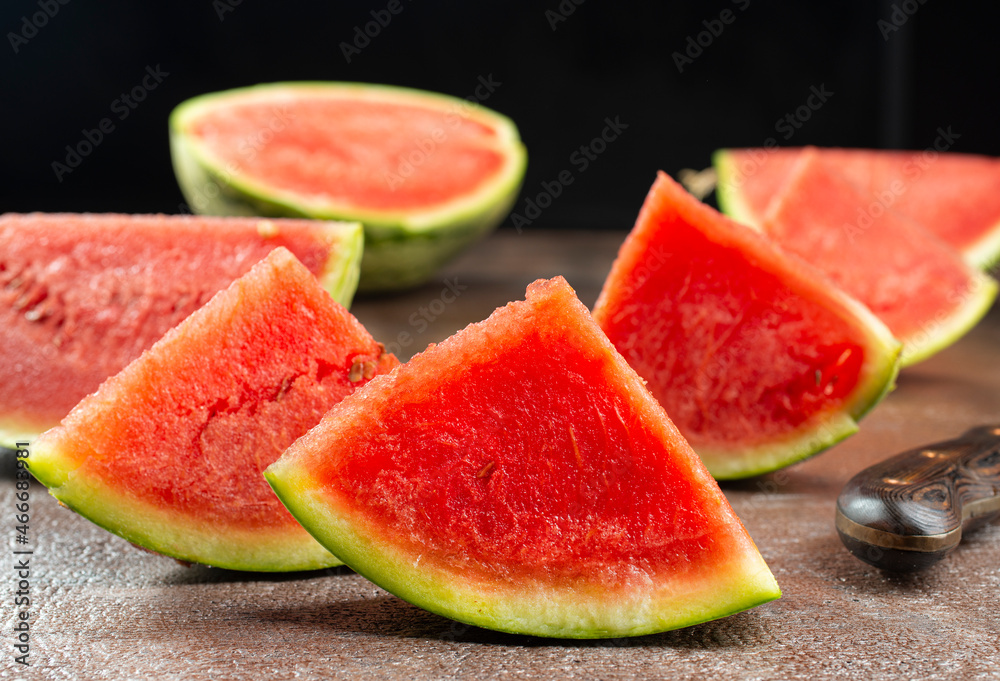 Fresh sliced watermelon on dark background