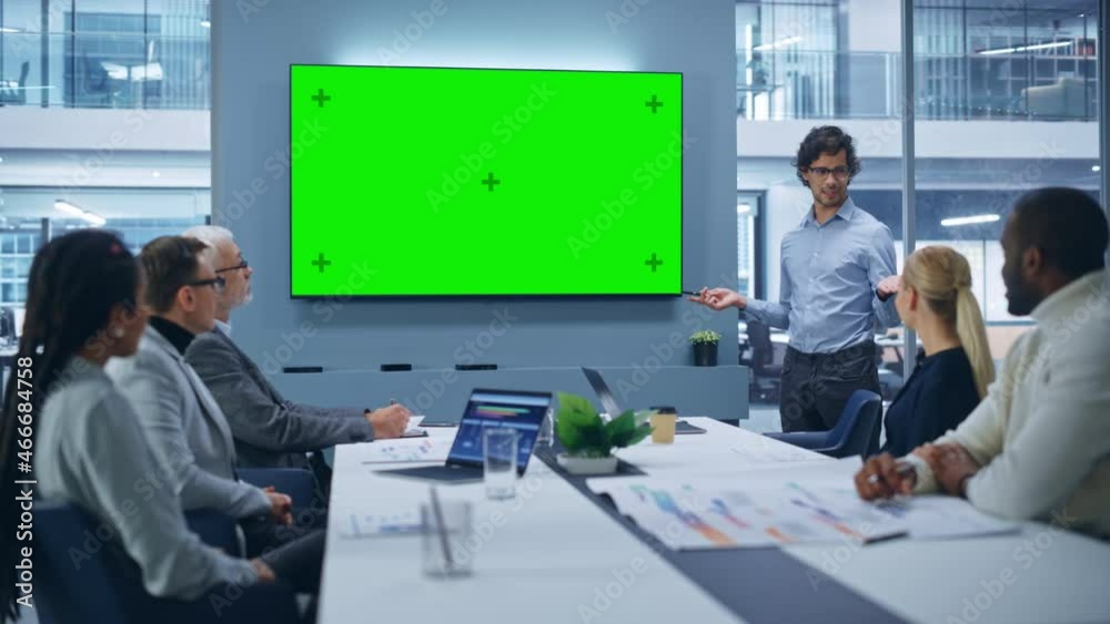 Office Conference Room Meeting Presentation: Charismatic Latin Businessman Talks, Uses Green Screen Chroma Key Wall TV. Successfully Presenting a e-Commerce Product to Group of Multi-Ethnic Investors