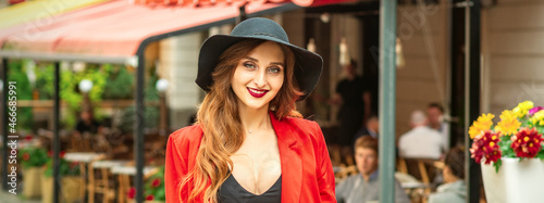 Woman is posing in the city street